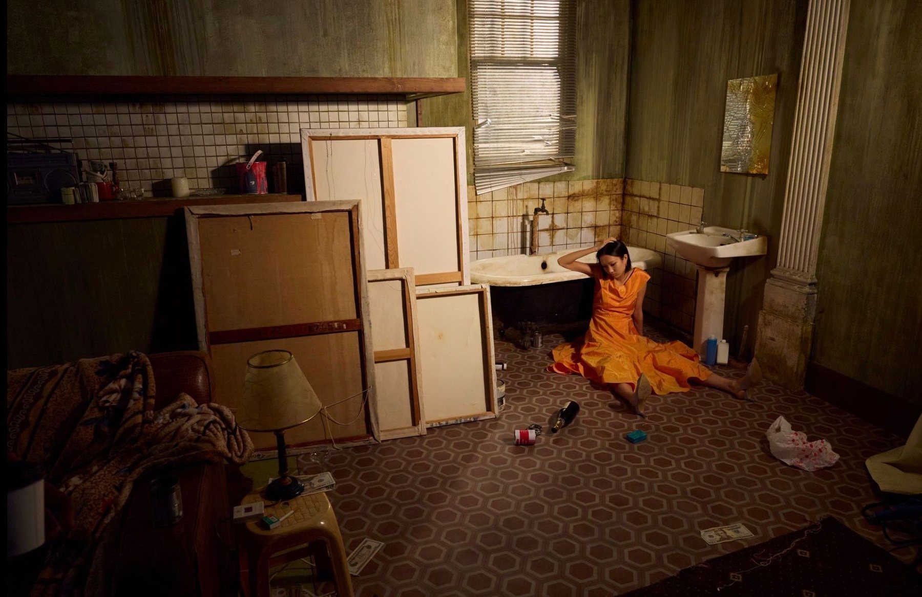 Woman in an orange dress beside a bath for Daddy’s Art