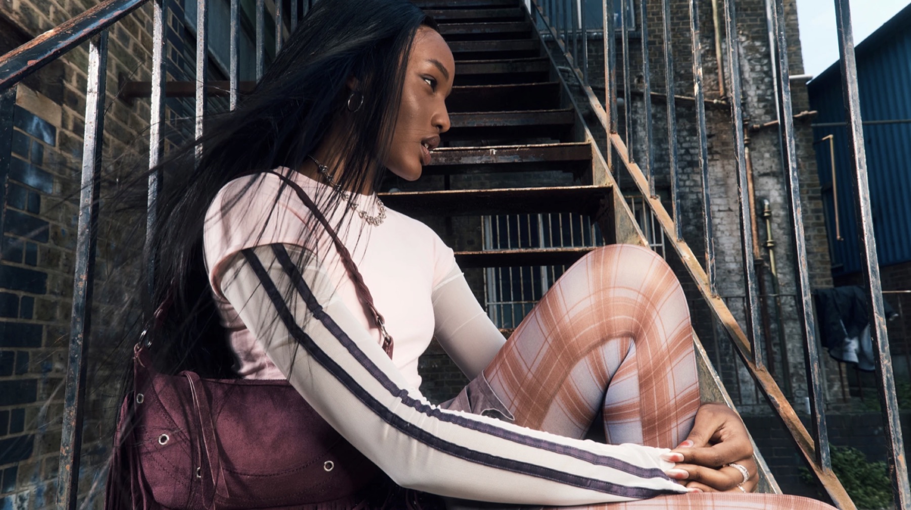Rimmel London campaign portrait on an exterior staircase